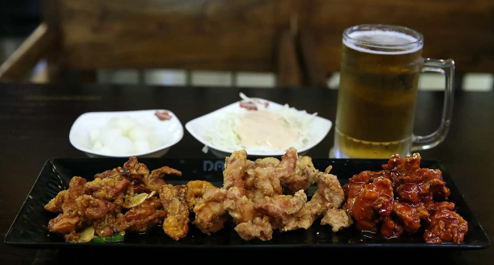 Korean fried chicken in soy, plain and spicy versions, served with beer