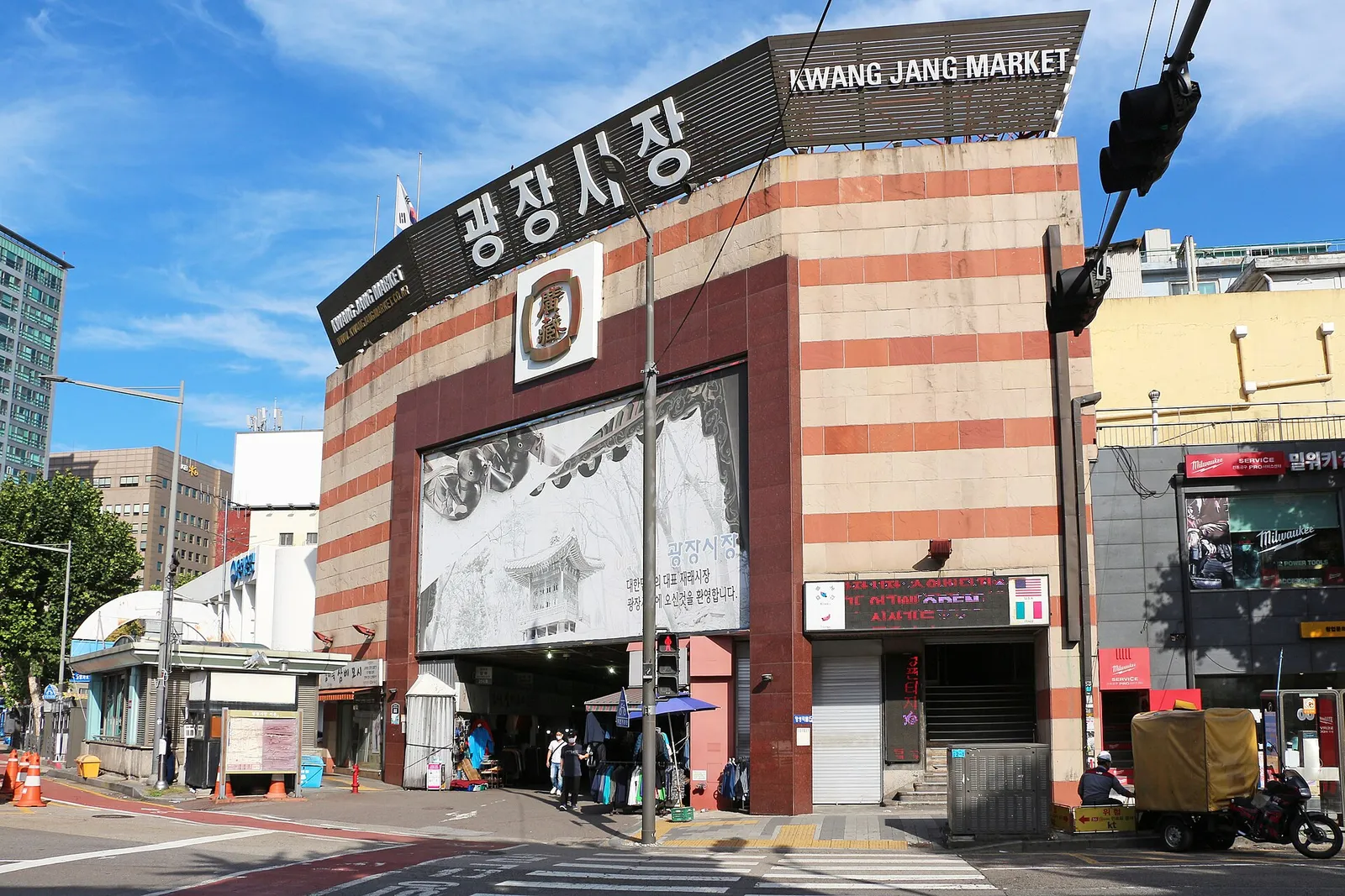 Diners eating at counter stalls in Gwangjang Market