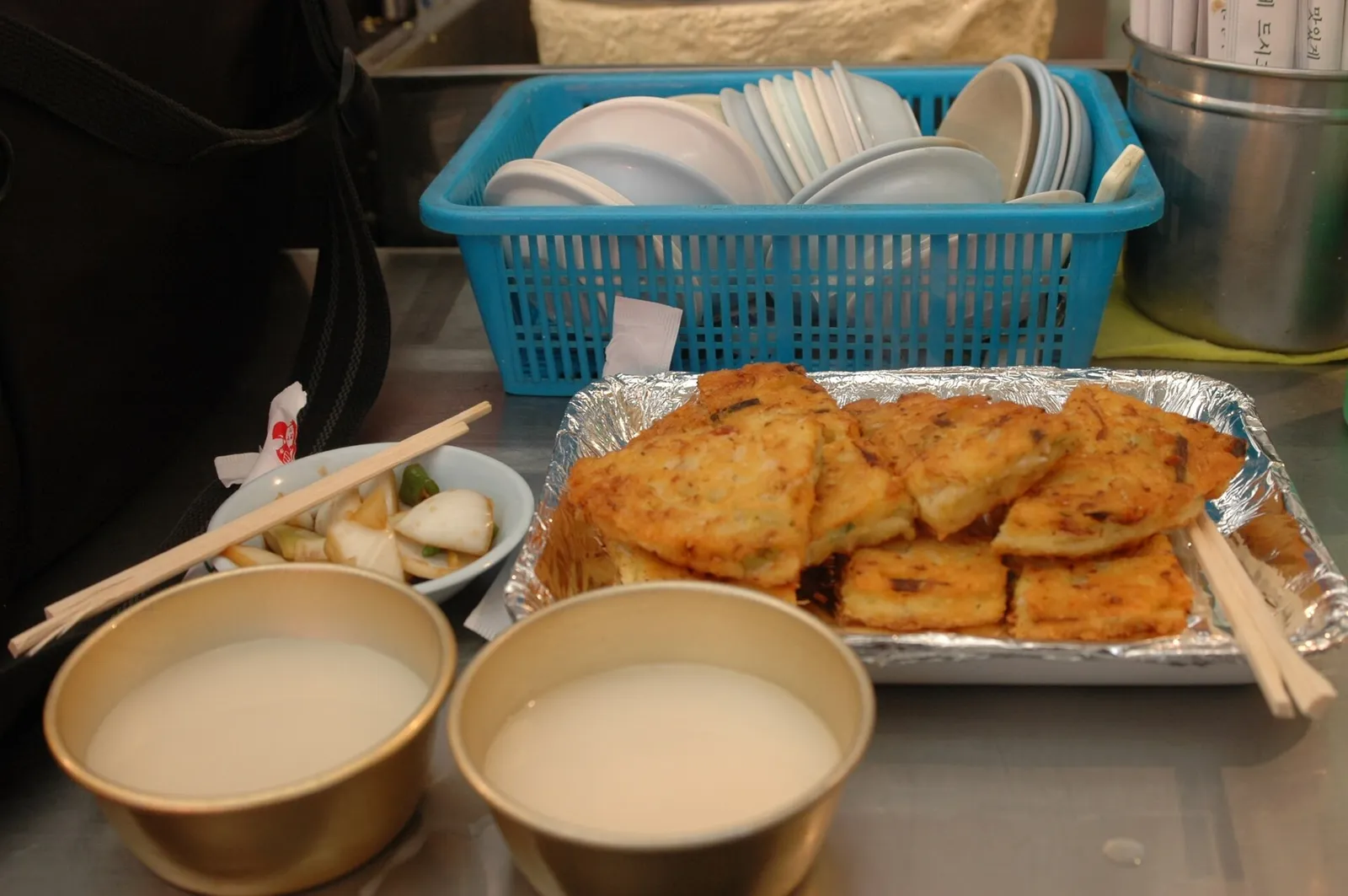 Bindaetteok mung bean pancakes served with makgeolli rice wine