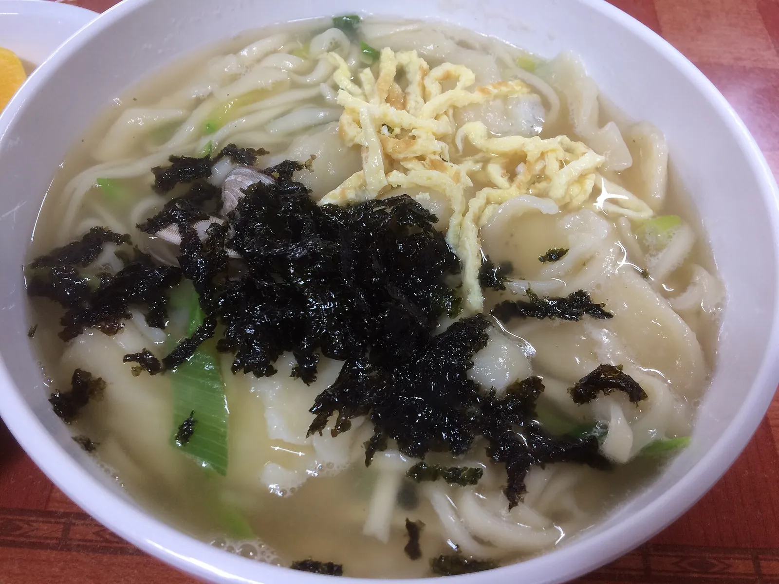 A bowl of kal-jebi, knife-cut noodles with hand-torn dough flakes