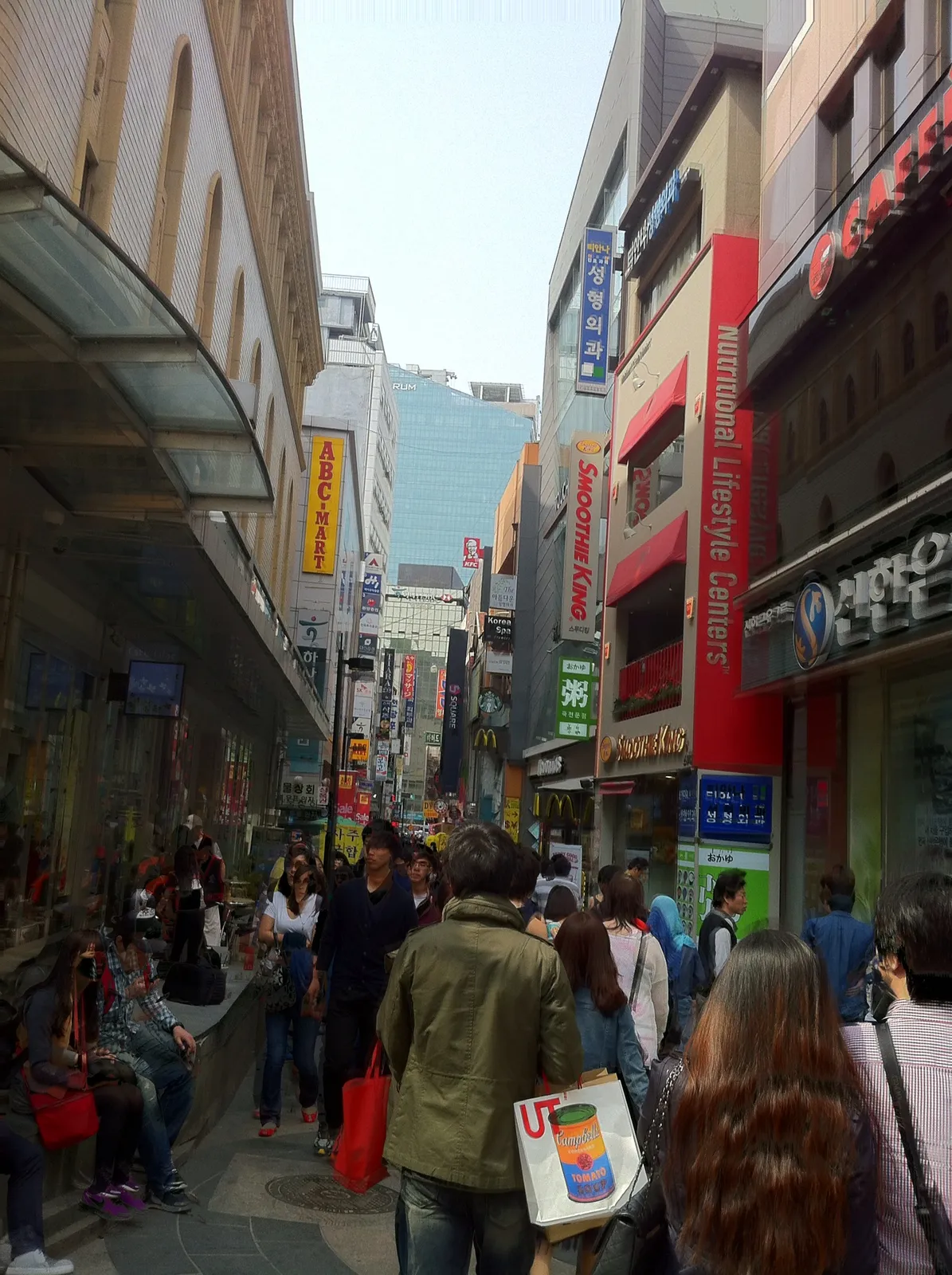 A pedestrian shopping street in Myeongdong lined with shops