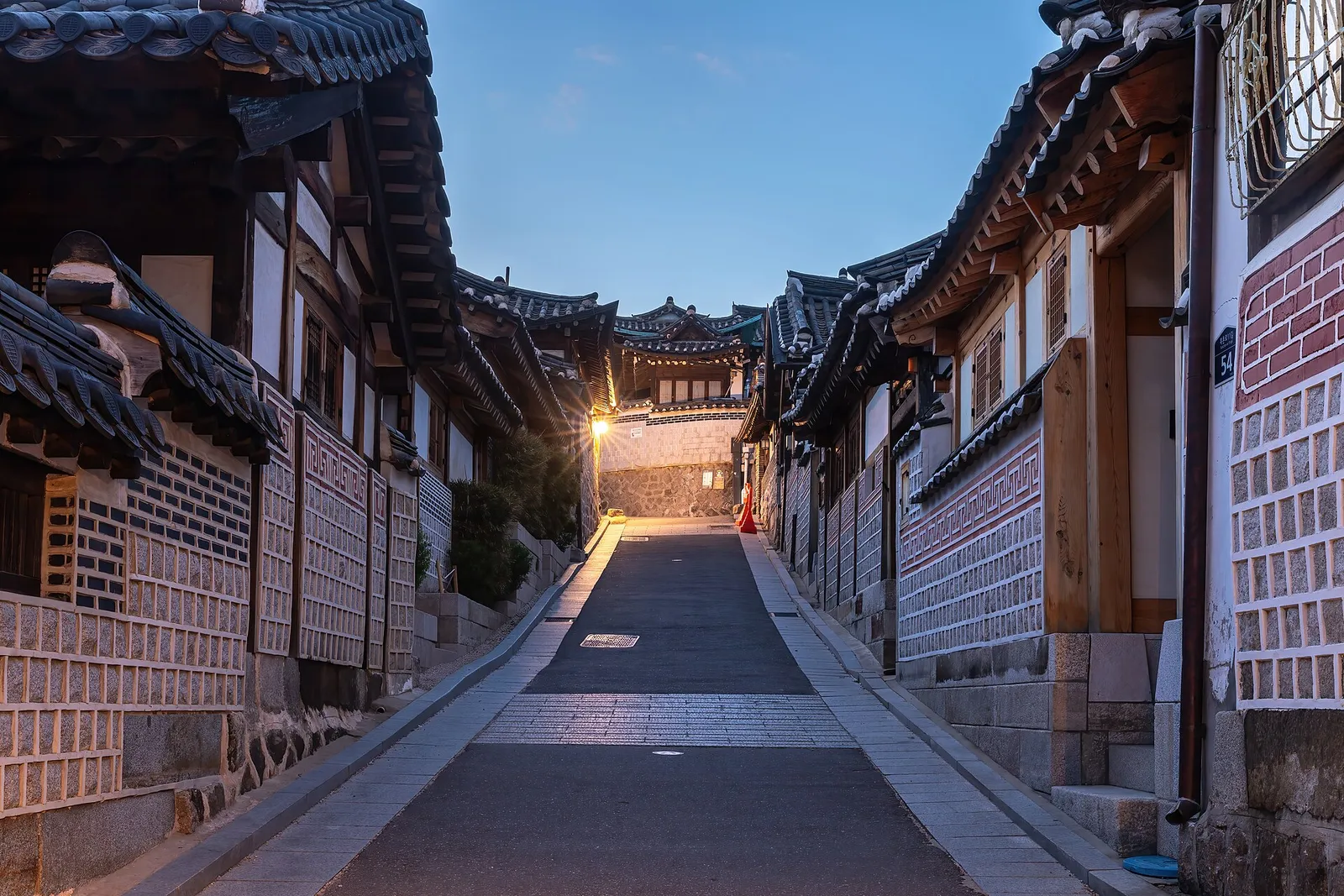A lane of traditional hanok houses in Bukchon Hanok Village at dusk